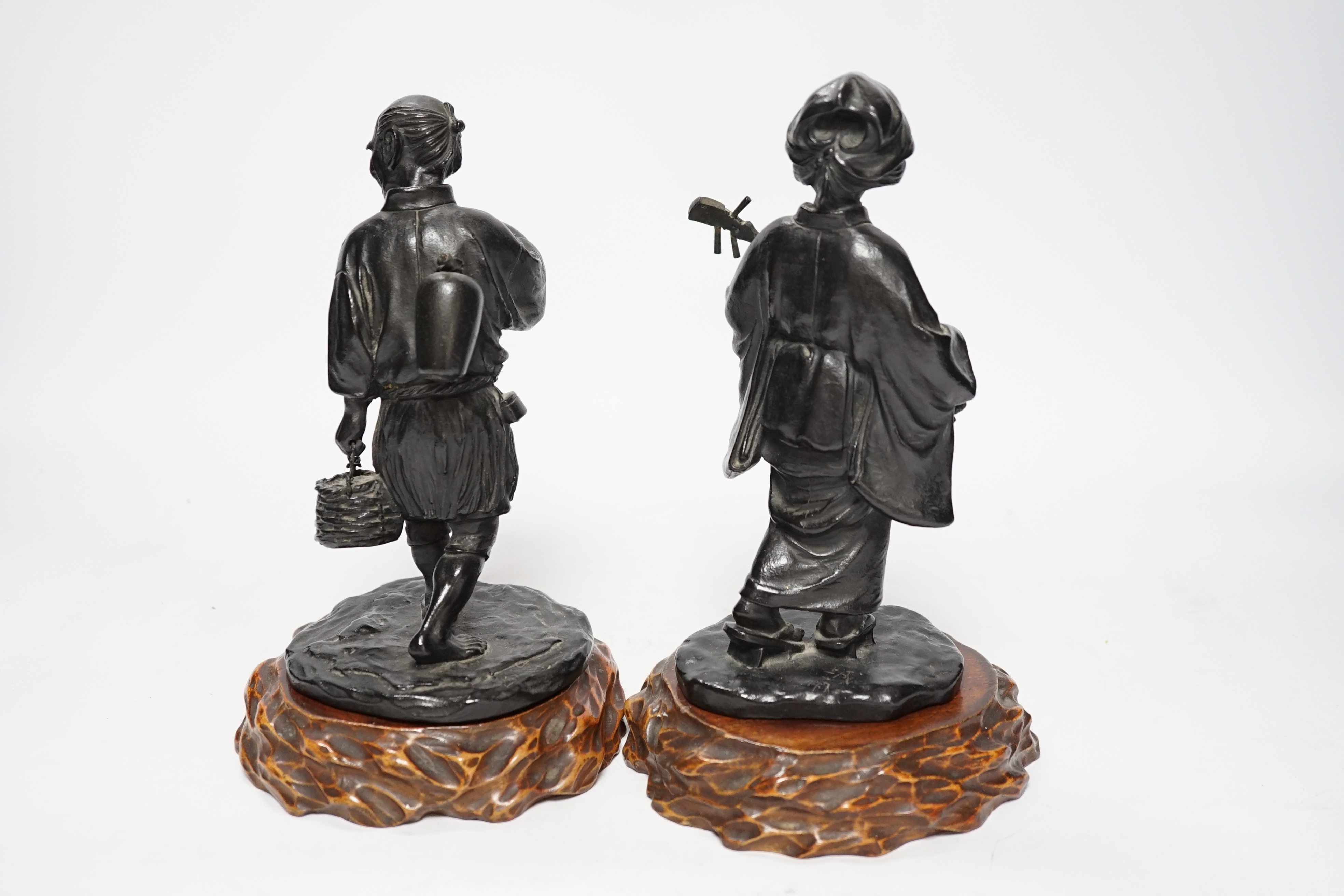 Two Japanese Meiji period bronzes, a water carrier and a woman playing a Shamisen, both signed, each with wooden plinths, largest 22cm high